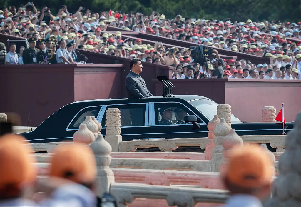 Xi Jinping looked on from his limousine's open sunroof (Kevin Frayer/Getty Images)