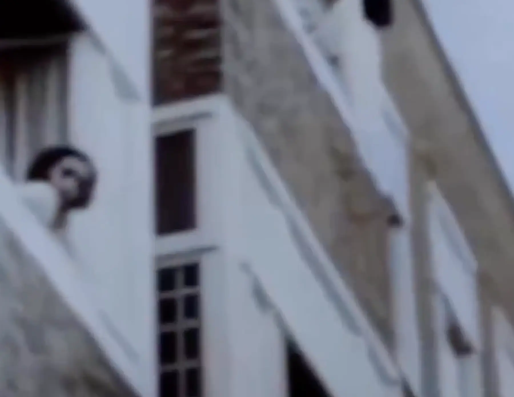 Anne Frank, who was around 12 at the time, can be seen looking out of her window.