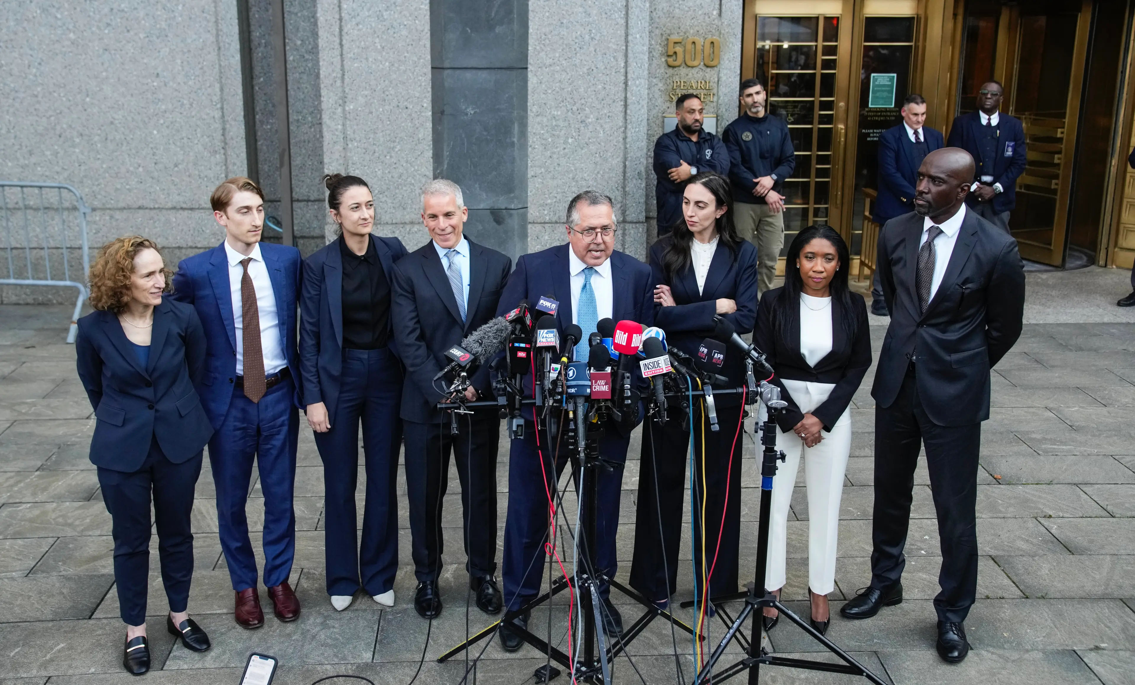 Diddy's team of legal eagles seen celebrating the verdict outside court (Eduardo Munoz Alvarez/Getty Images)