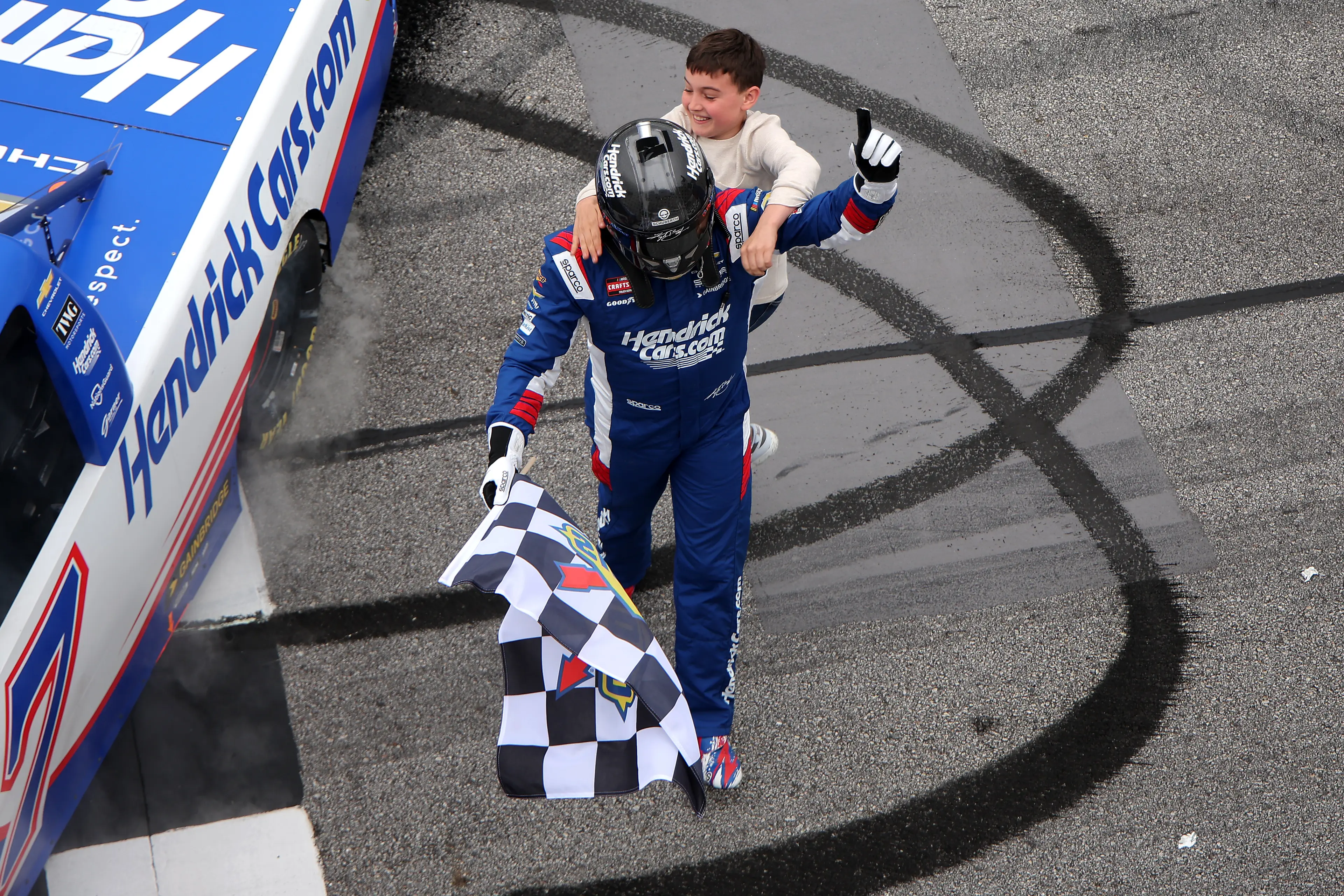 The father and son seen celebrating Busch's win at the NASCAR Craftsman Truck Series Fr8 Racing 208 (Jonathan Bachman/Getty Images)