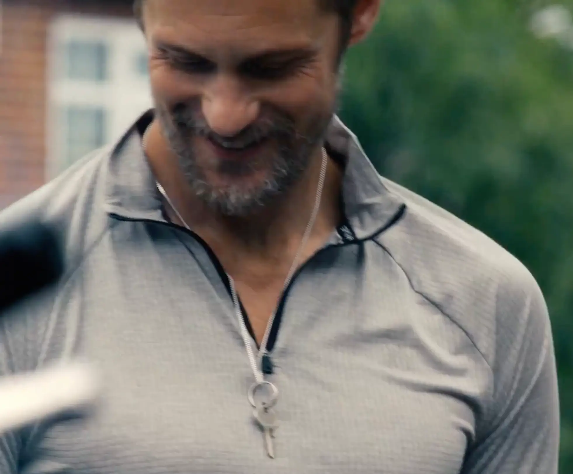 Alex Skarsgård's Ray is shown with a key on a chain around his neck (A24)