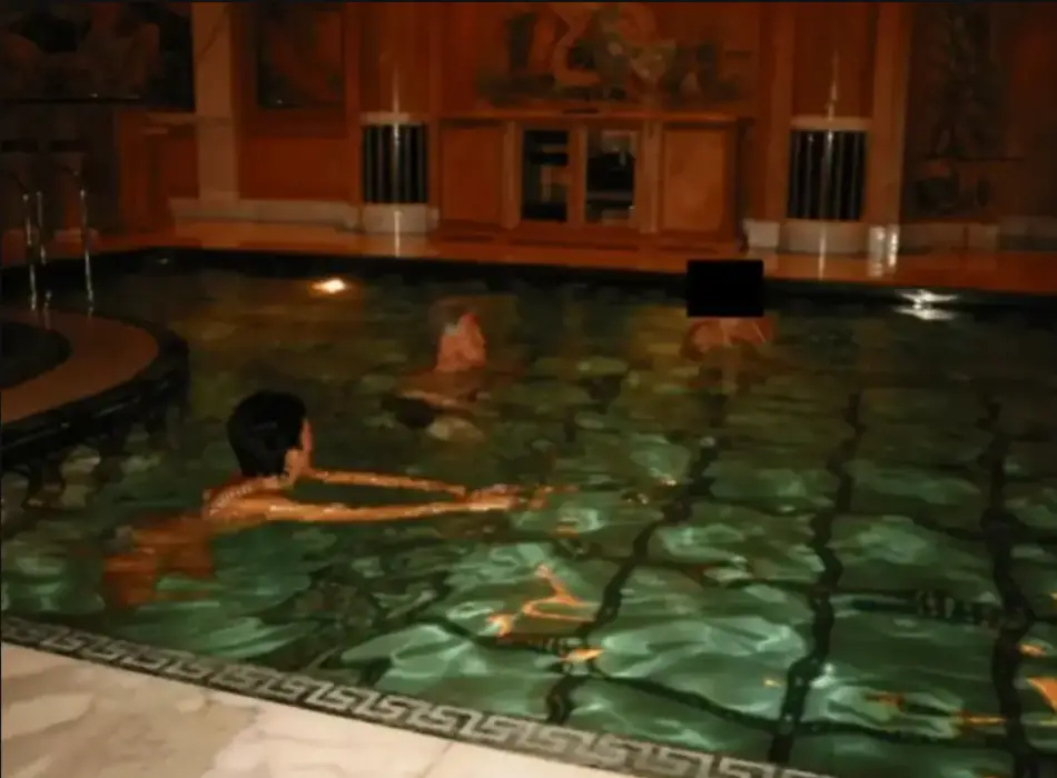 He was also pictured swimming in a pool with Maxwell (DOJ)