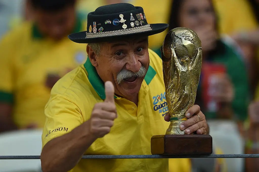 He was known for carrying his replica trophy to every game (Photo by EITAN ABRAMOVICH / AFP via Getty Images)