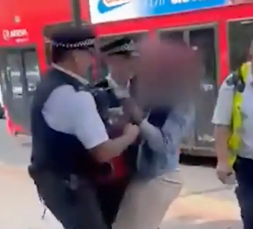 The woman was held by police by the bus stop.