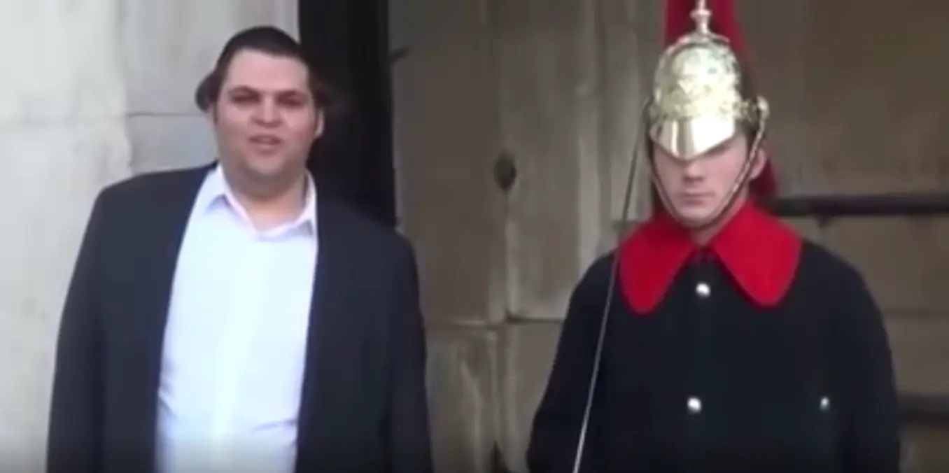 The American can't help but tease the guard.