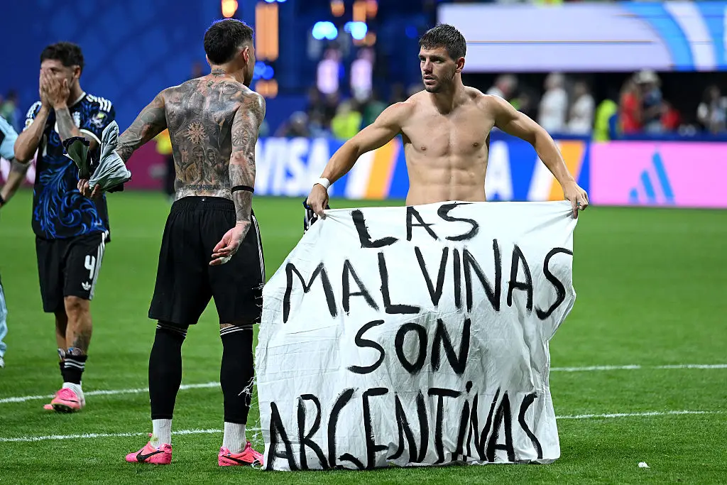 Players held the sign up on the pitch (Shaun Botterill/Getty Images)