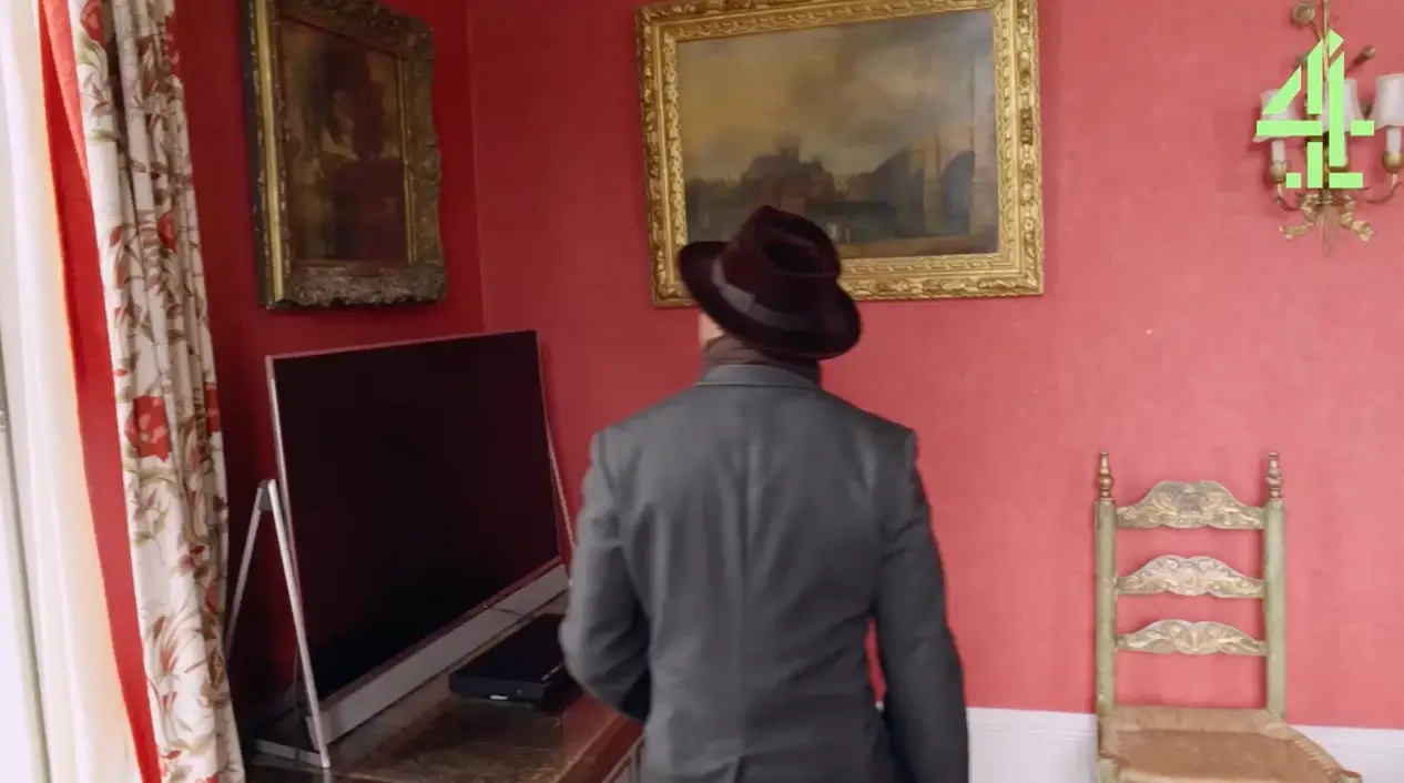 The picture was hung up in the spare room behind the telly.