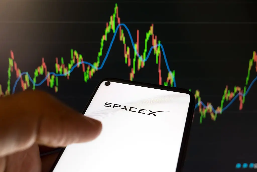Elon Musk says he's giving away his SpaceX shares to US kids (Photo Illustration by Nikolas Kokovlis/NurPhoto via Getty Images)