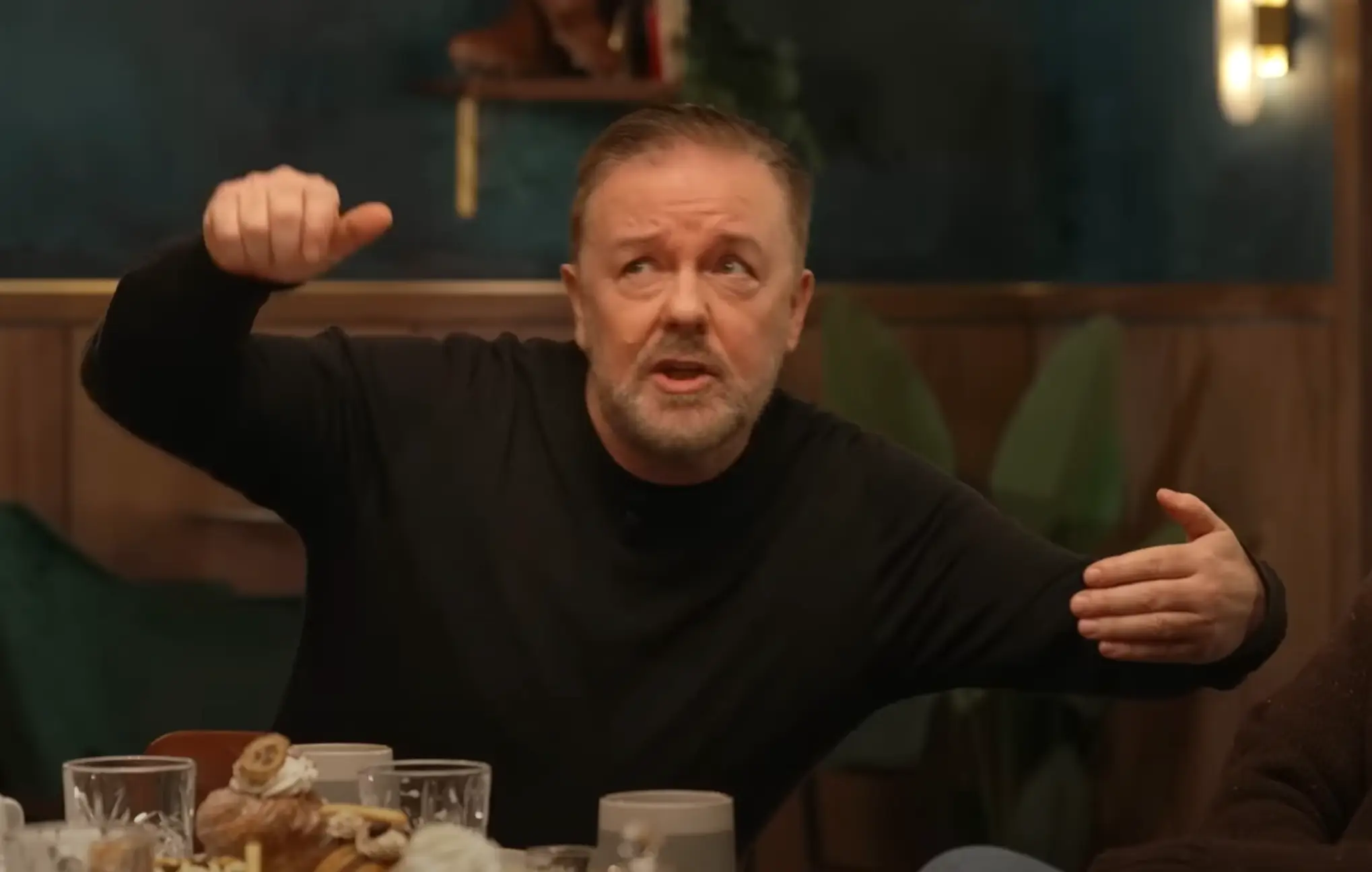 Gervais reenacted the moment the selfie was taken. Horrifying. (YouTube / @theoverlap)