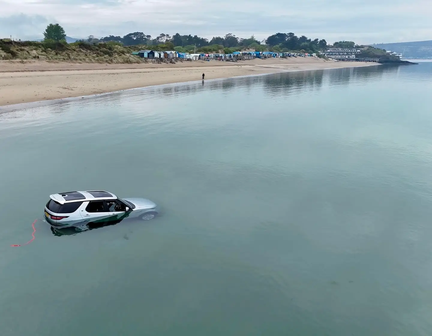People spotted the car on the beach being submerged by the tide at around 7:30am on Sunday (Wales News Service)