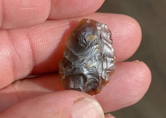 A prehistoric flint arrowhead was among several discovered during the dig (National Highways/AMS)