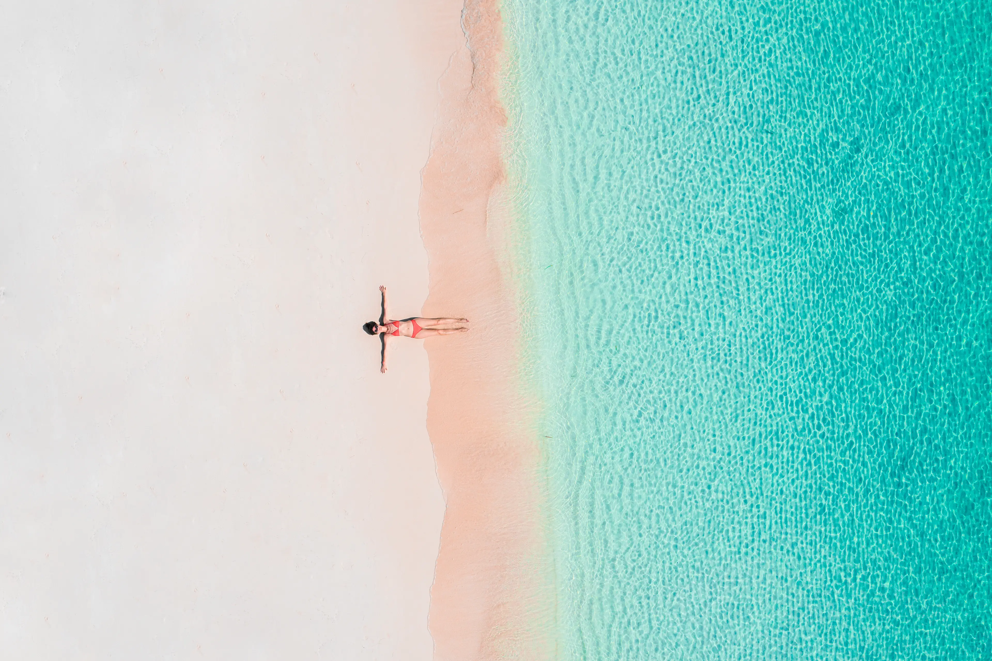 A woman tans on a beach. (Marco Bottigelli/Getty Images)