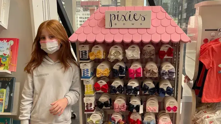 Pixie Curtis with a rack of bows from her very own business.