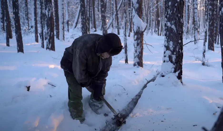 Samuil must constantly chop wood to heat his home. (YouTube/Kiun B)