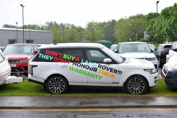 The vehicles are right outside the Land Rover dealership.