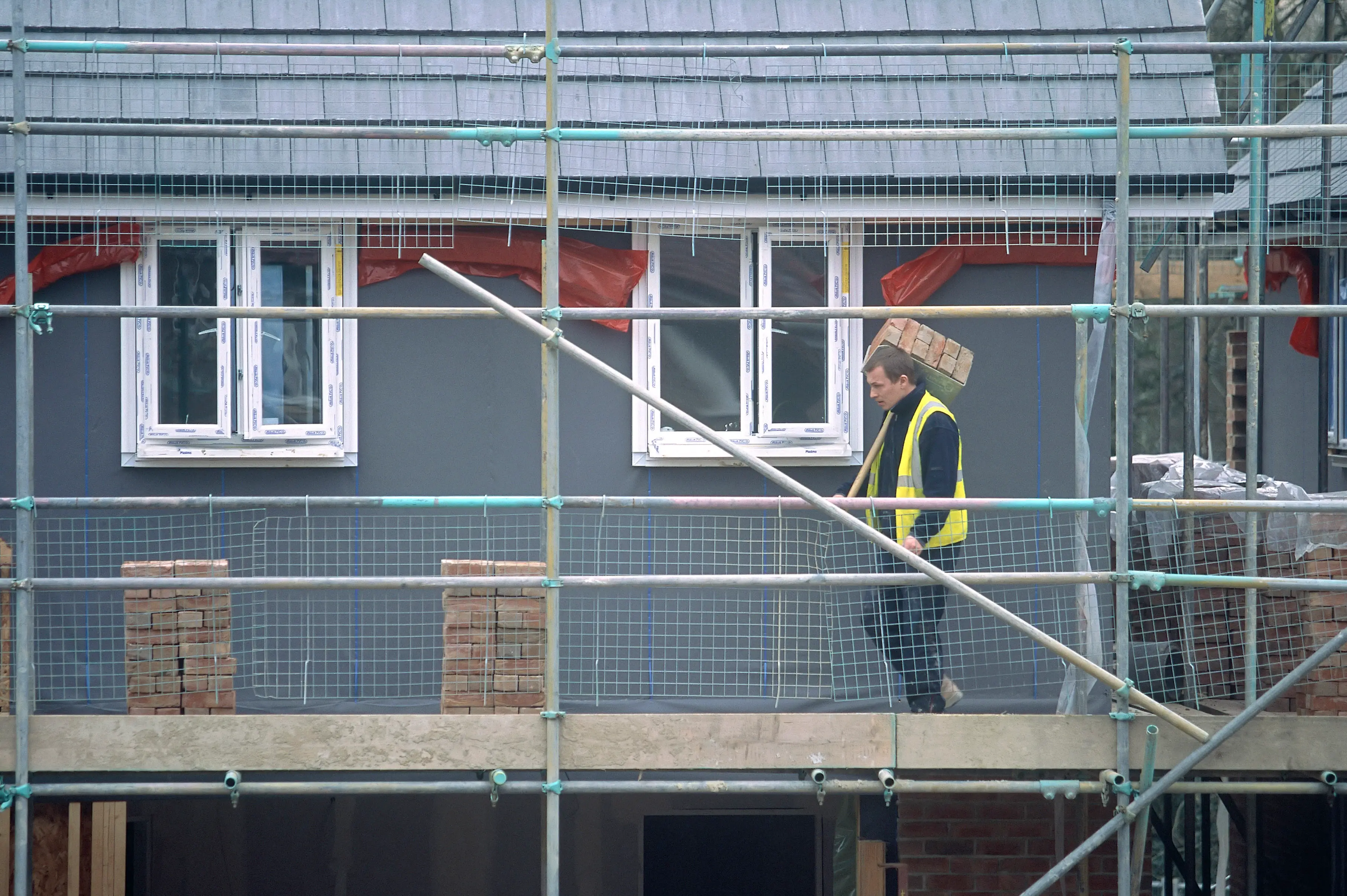 Here's what a hod carrier looks like, for those still unsure (Jean-Francois Cardella/Construction Photography/Avalon/Getty Images)