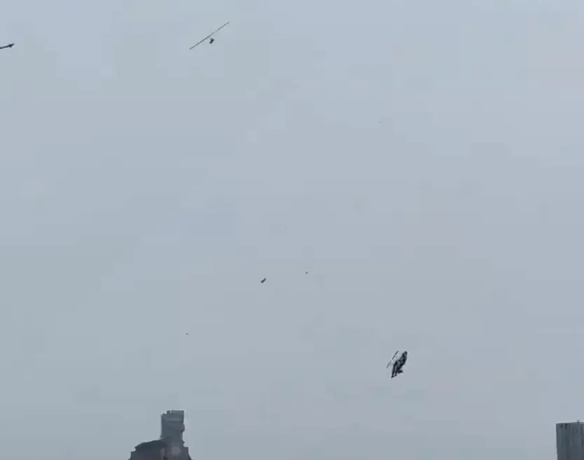 The helicopter blades were seen detached from the aircraft as it crashed (X/@MikeyKayFilms)