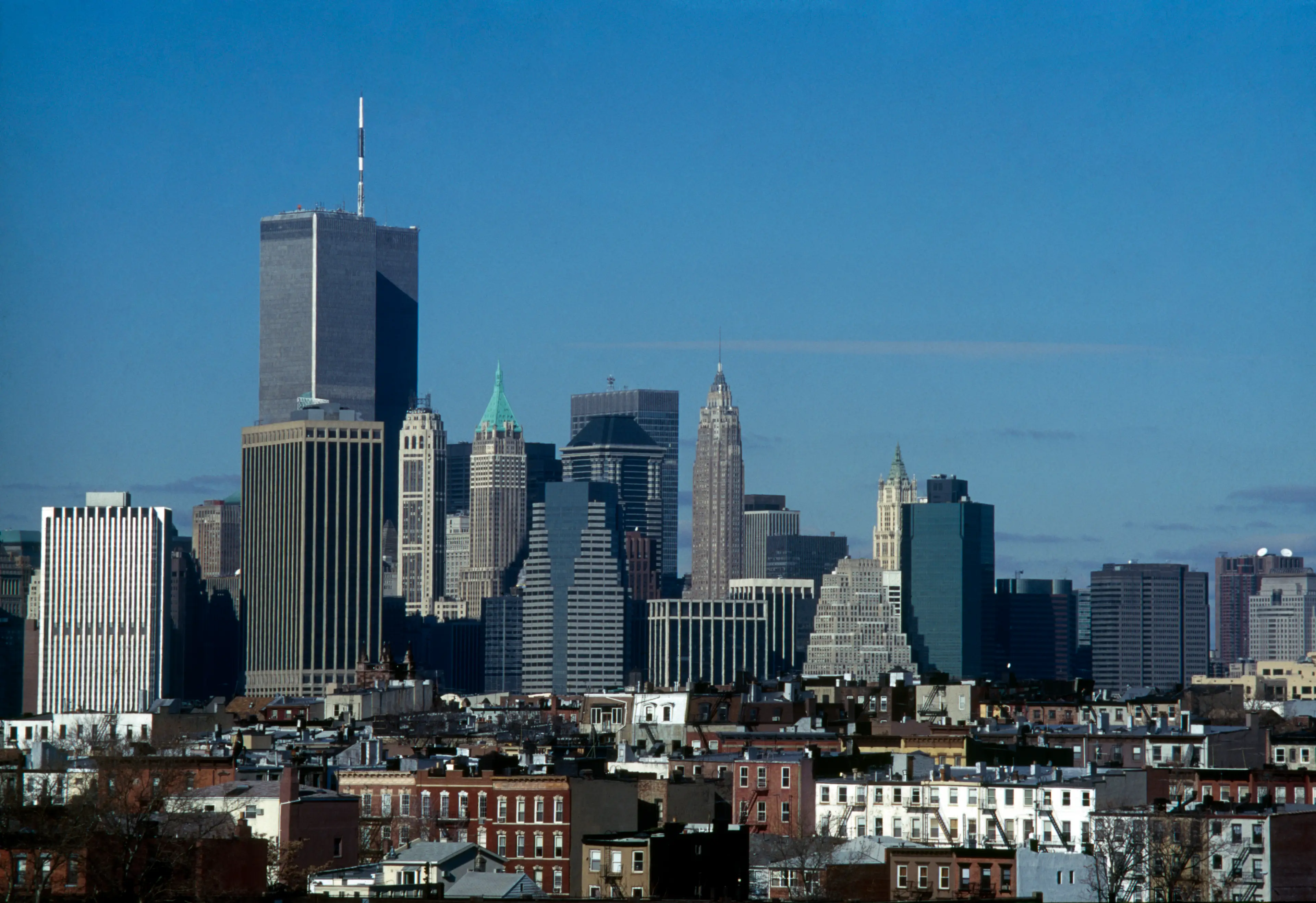 The lower Manhattan skyline pictured in 2000, featuring the World Trade Center in the top left and 40 Wall Street, which is identifiable by its green spire (Caroline Cortizo/Getty Images)