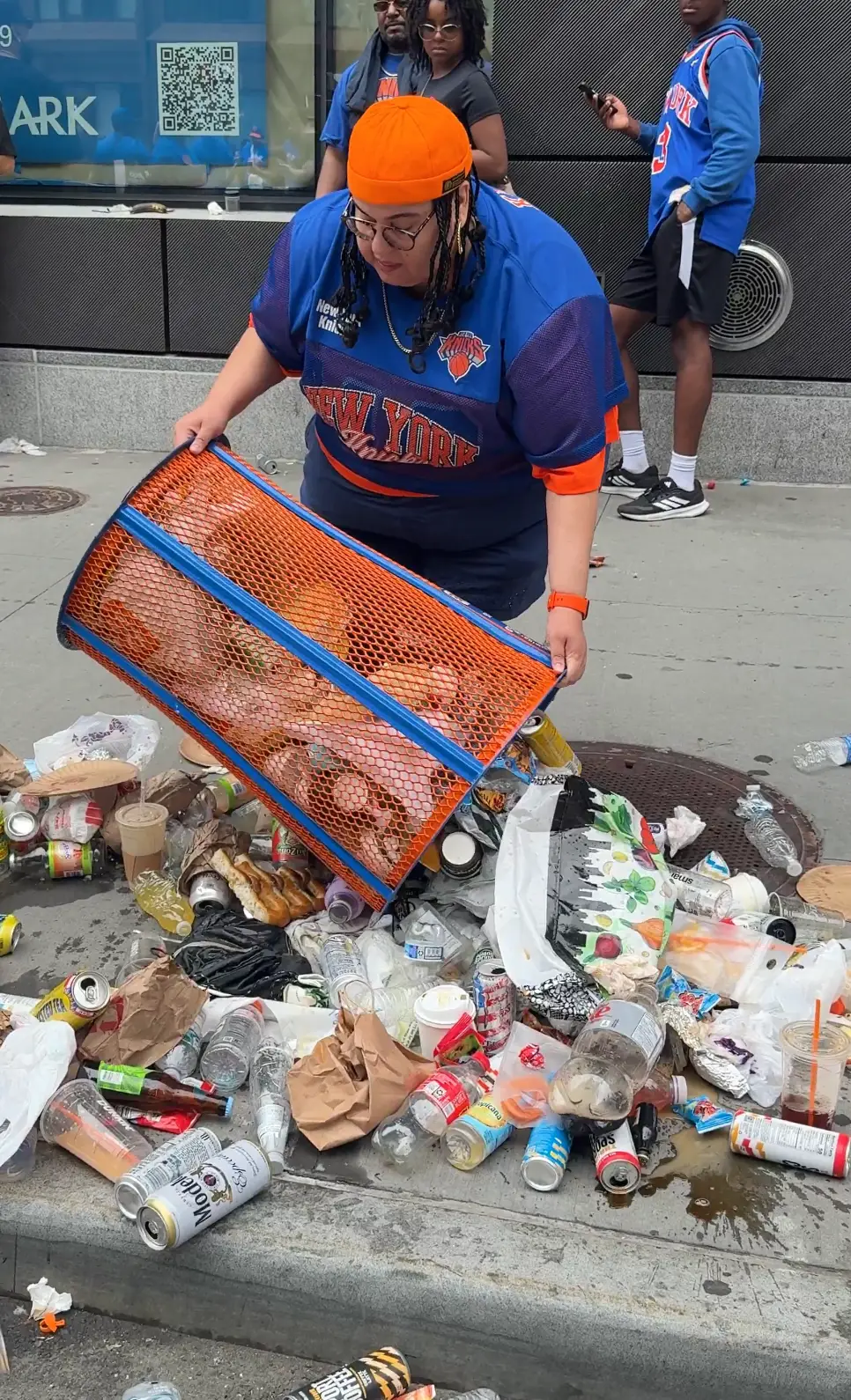 A woman who was pictured emptying a New York Knicks bin during their parade and taking it as a souvenir has lost her job (X)