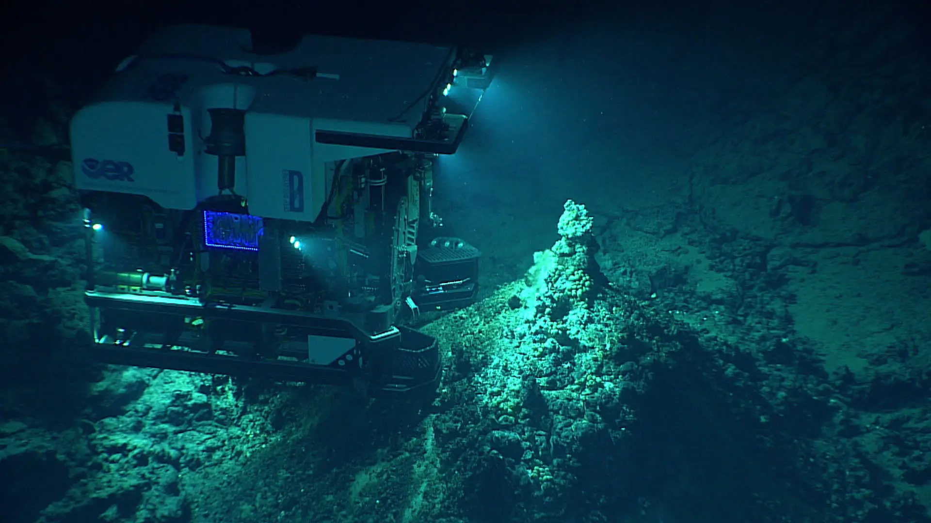 A deep-ocean submersible uses its lights to illuminate a hydrothermal vent field at Chammoro Seamount, within the Mariana Trench (NOAA Office of Ocean Exploration and Research/NOAA)