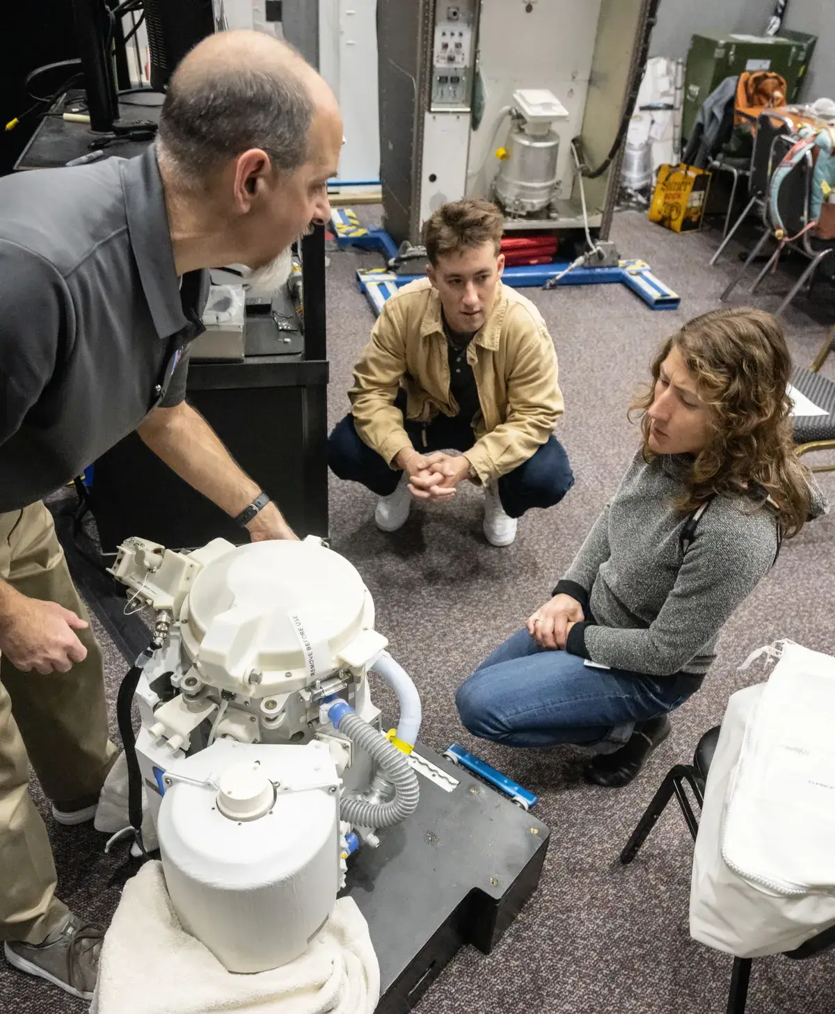 Christina Koch is shown a test version of the space craft's toilet (NASA)