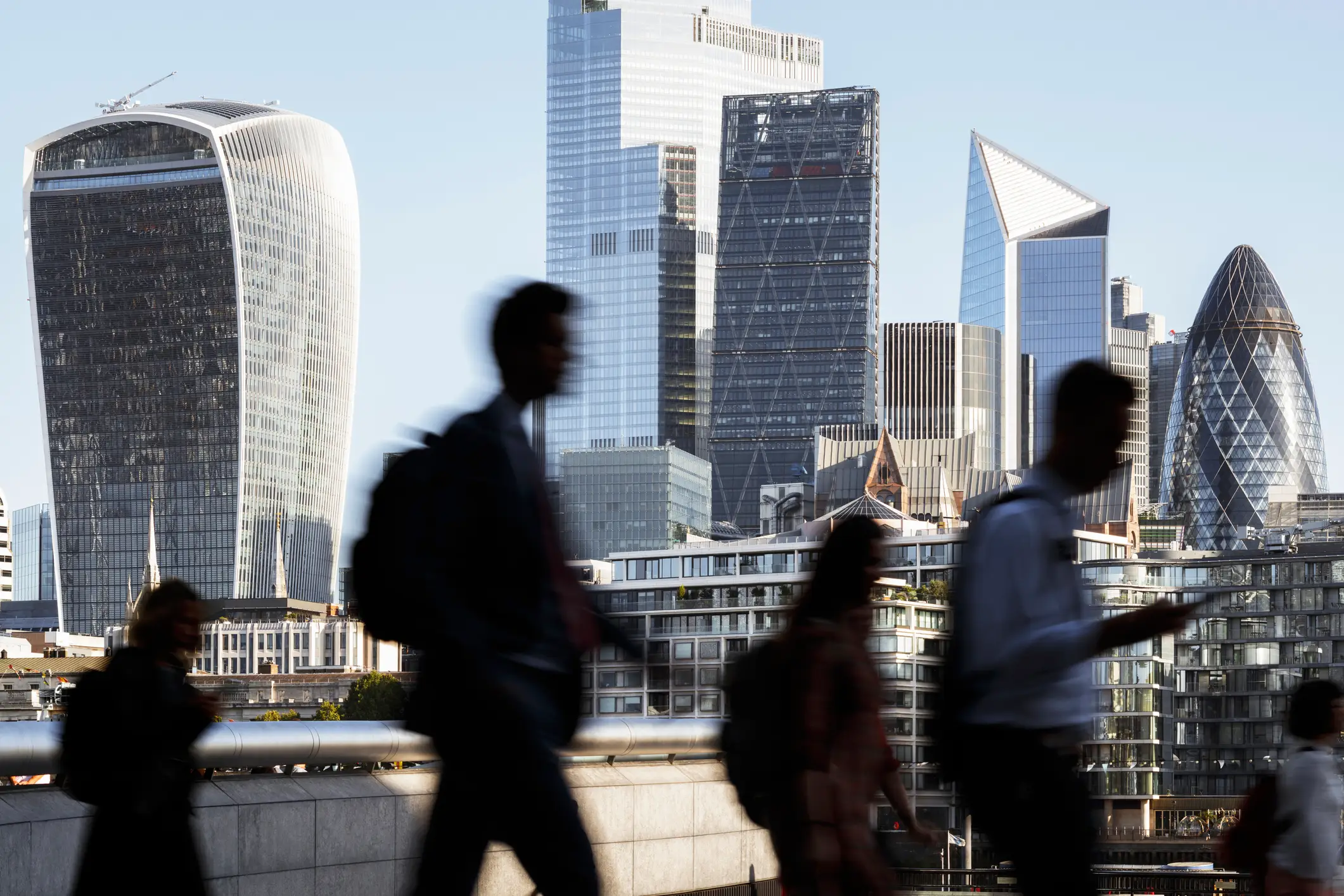 London business people walking to work with view of the financial district behind (Getty Stock Images)