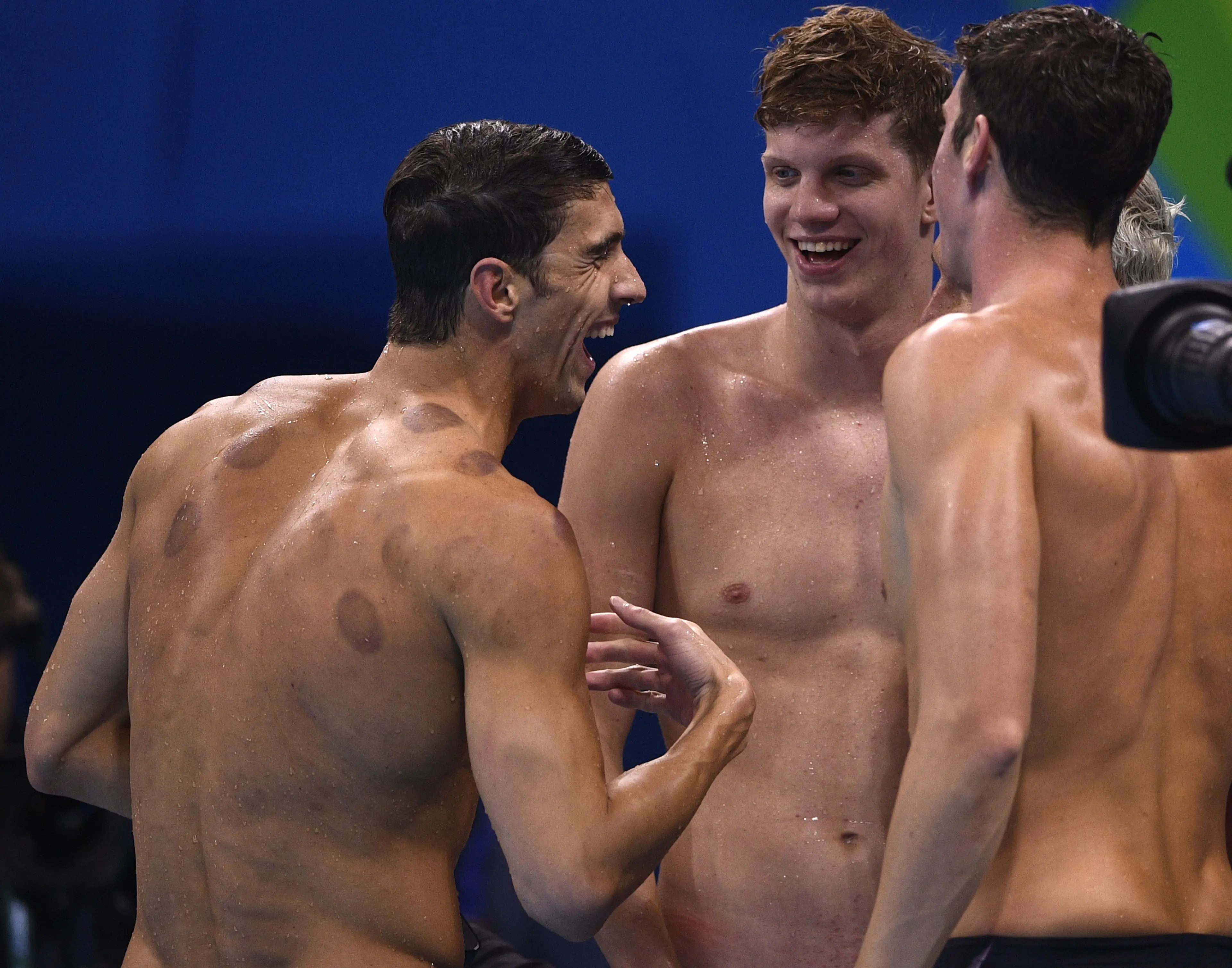 Michael Phelps celebrating gold with Ryan Lochte and Conor Dwyer. (MARTIN BUREAU/AFP via Getty Images)