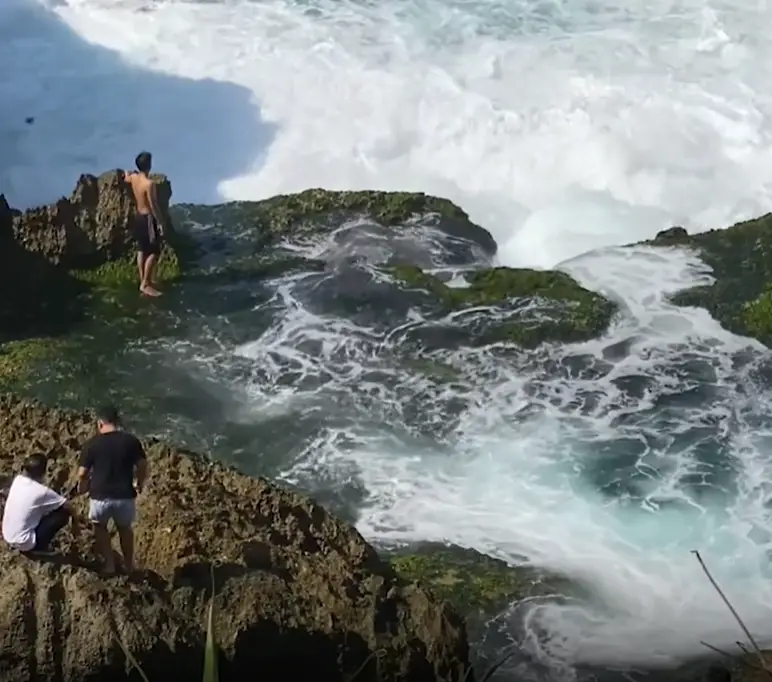 21-year-old Rony Josua Simanjuntak was standing by the sea (Asia Pacific Press via Viral Press)
