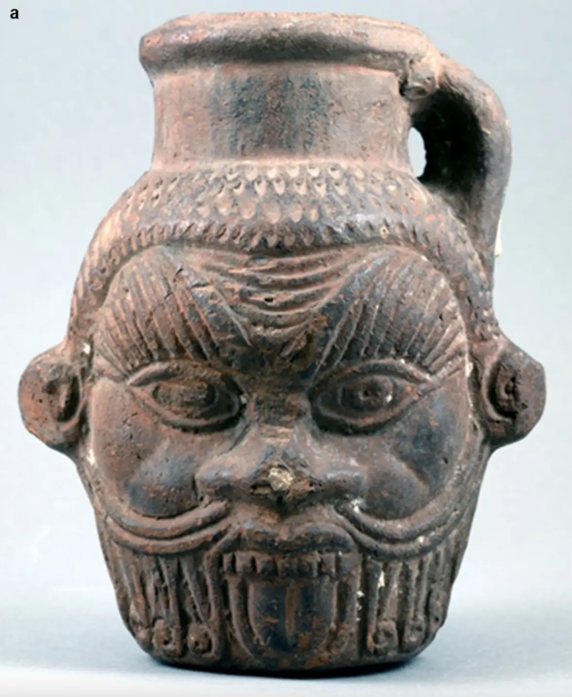 The mug honouring Bes, an Egyptian god associated with joy, fertility and household protection (Allard Pierson Museum / Stephan van der Linden)