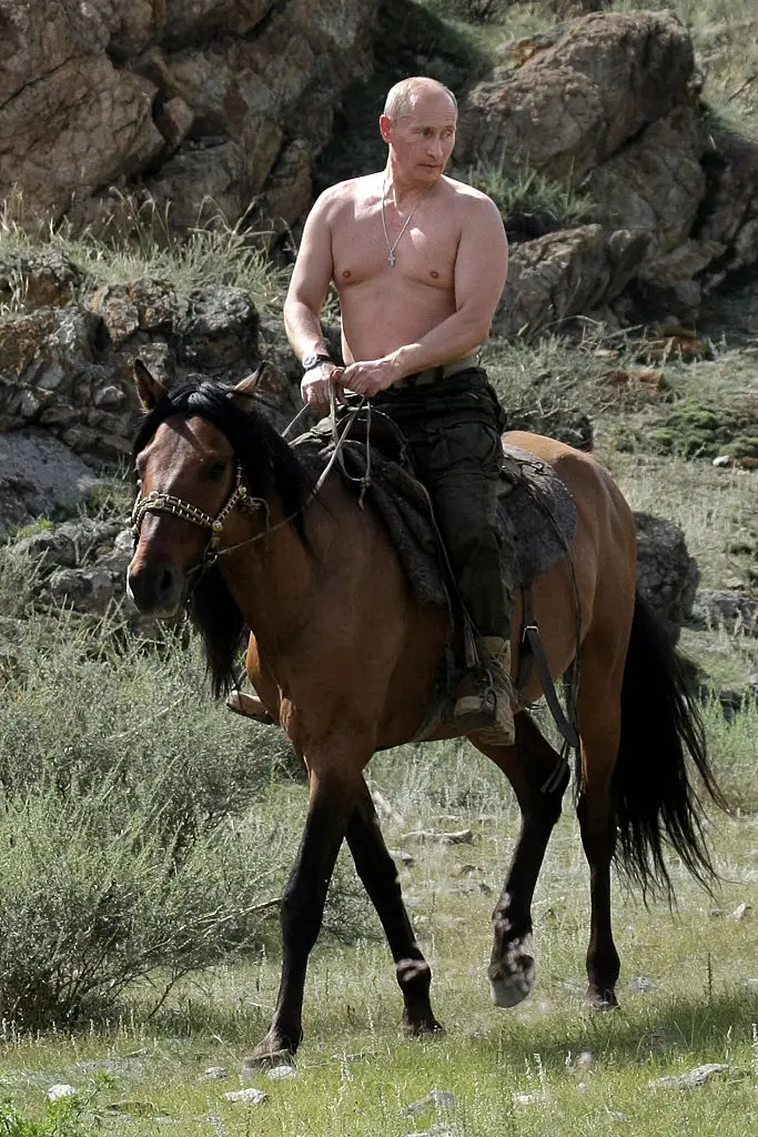 Putin pictured topless on horseback in 2009 (ALEXEY DRUZHININ/RIA NOVOSTI/AFP via Getty Images)