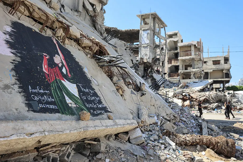 A mural of Macklemore on a bombed out building in Gaza City (Omar AL-QATTAA / AFP via Getty Images)