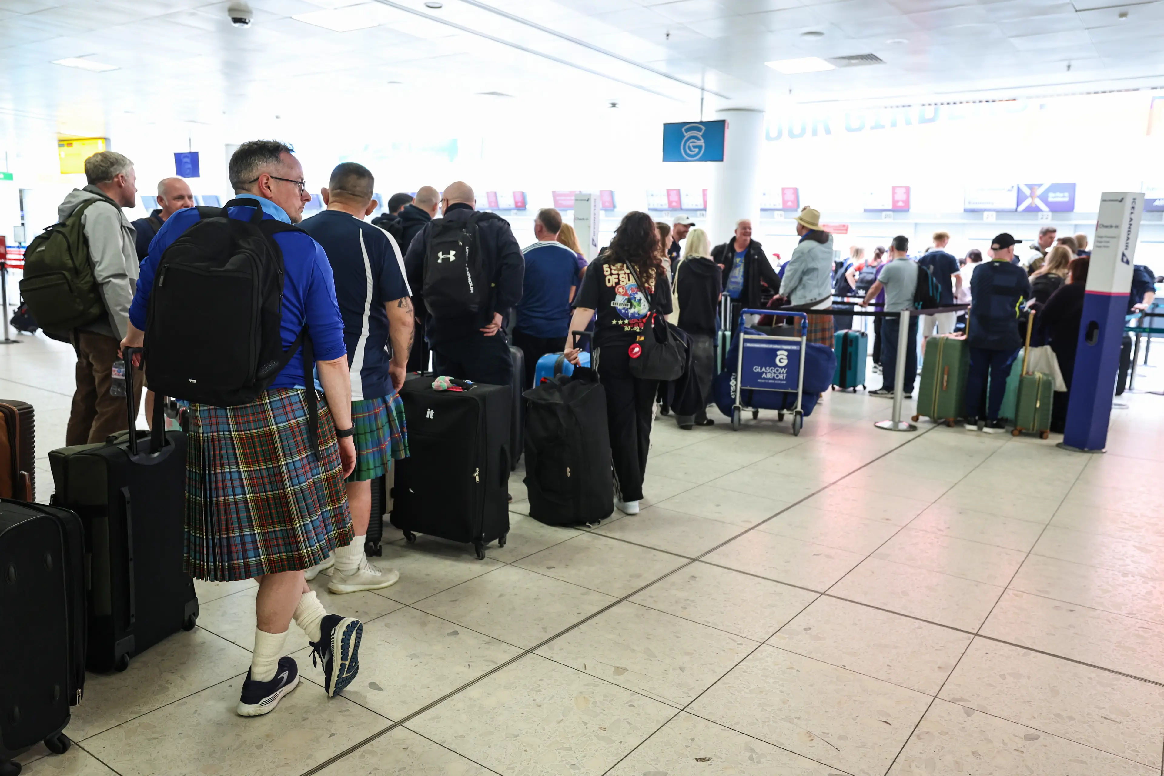 Scotland football fans at Glasgow Airport flying out to the USA for the 2026 World Cup (Ross MacDonald/SNS Group via Getty Images)