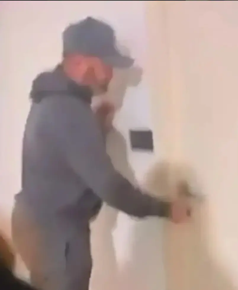 The viral clip shows him opening his flat while a woman waits behind. (X)