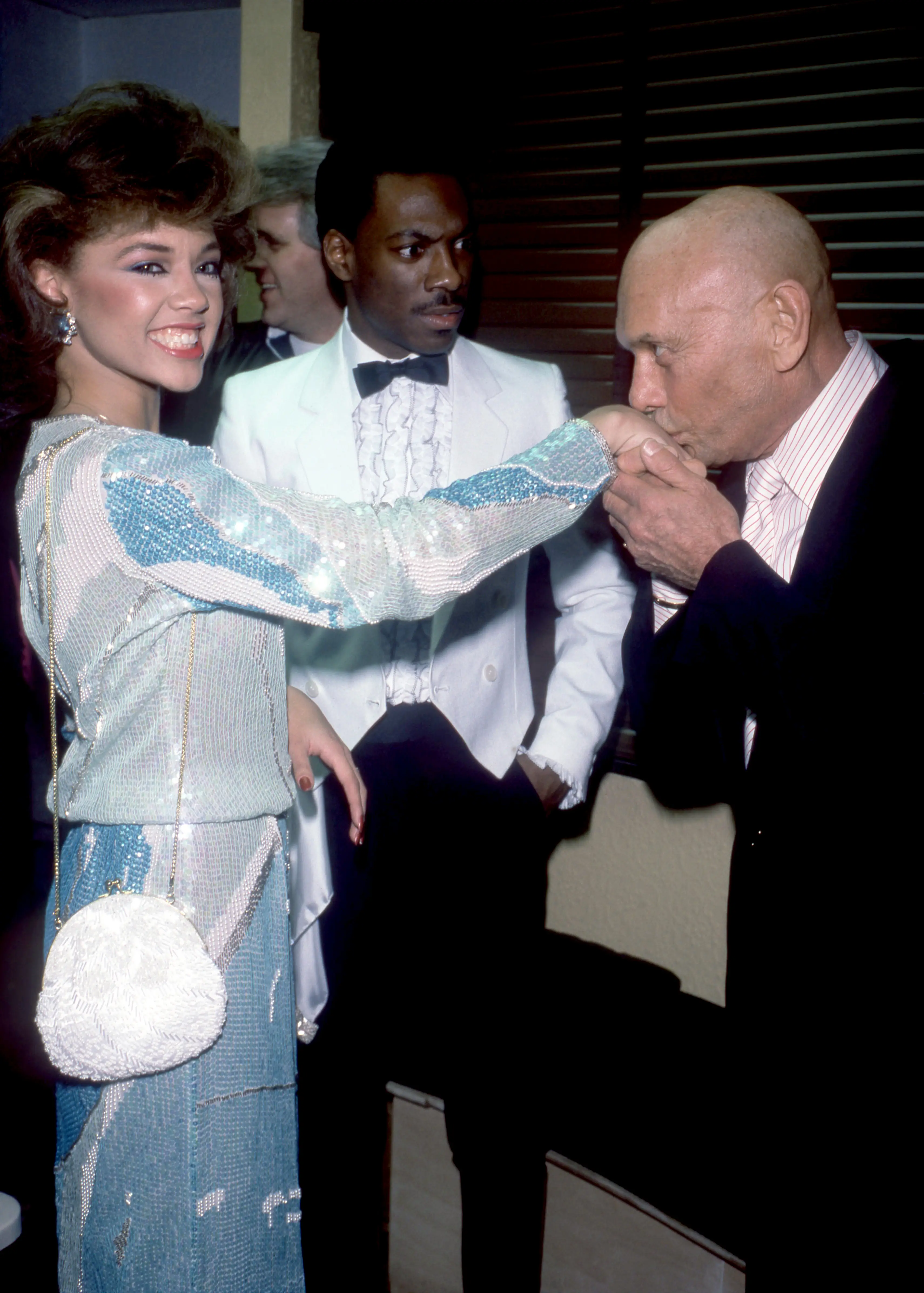 Murphy seen gasping as Yul Brynner kissed the hand of American singer and Miss America Vanessa L. Williams in 1984 (Oscar Abolafia/TPLP/Getty Images)