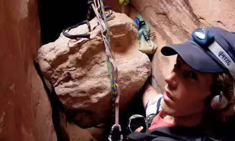 A photo showing Aron's arm tapped behind the boulder (Simon & Schuster)