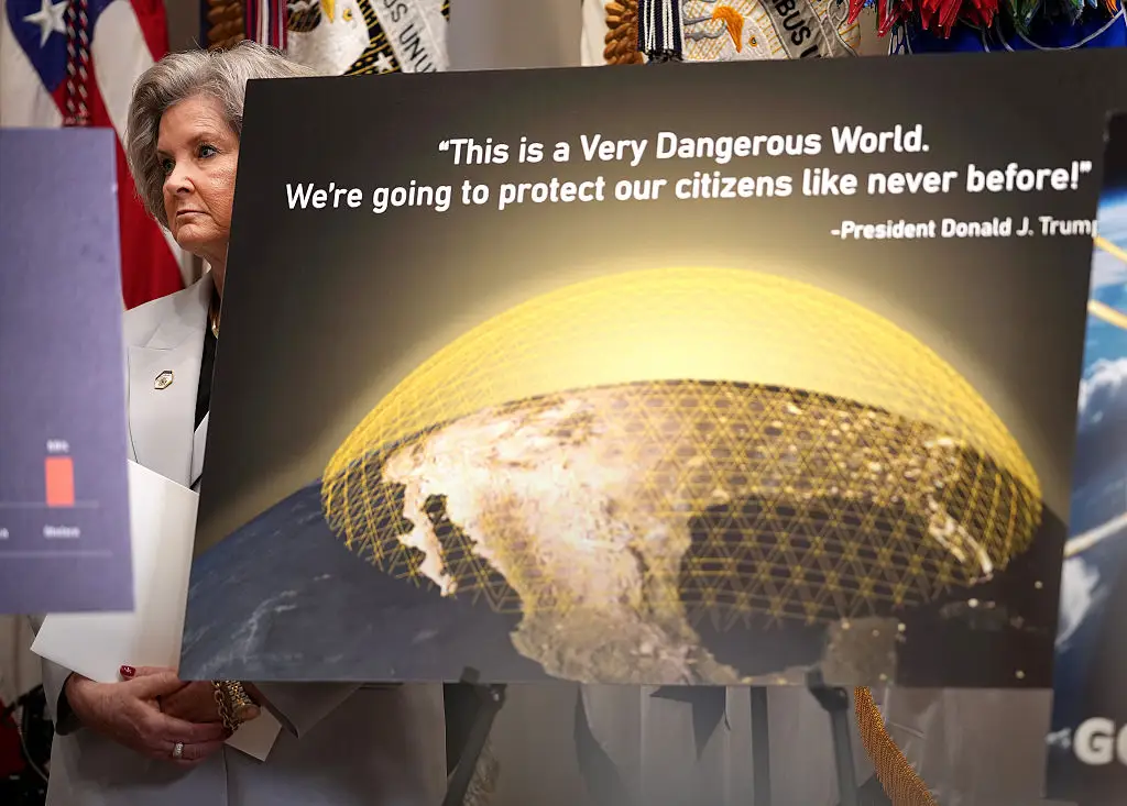 The message could be seen on one of the graphics behind Trump (Andrew Harnik/Getty Images)