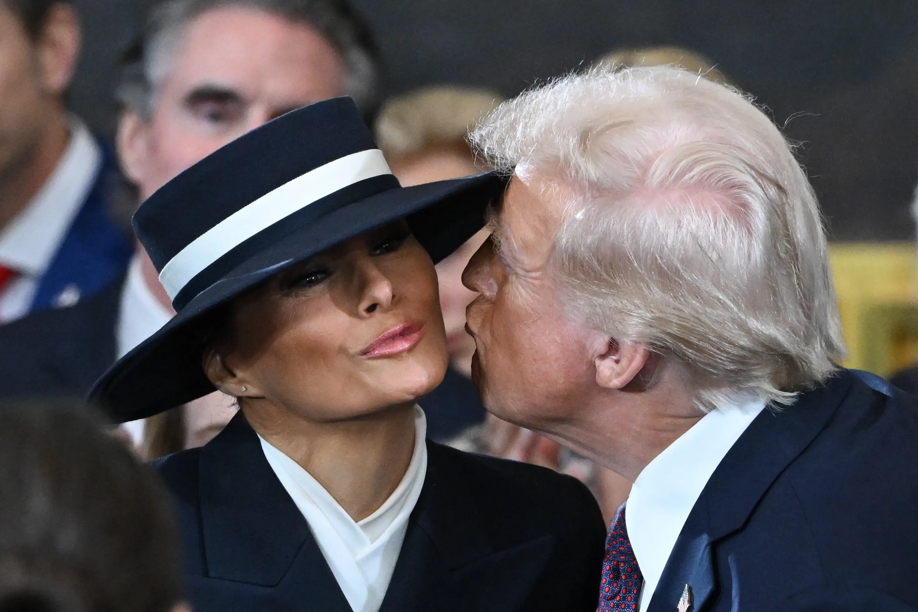 Melania's hat appeared to block Trump from landing a kiss on her cheek (Saul Loeb-Pool/Getty Images)