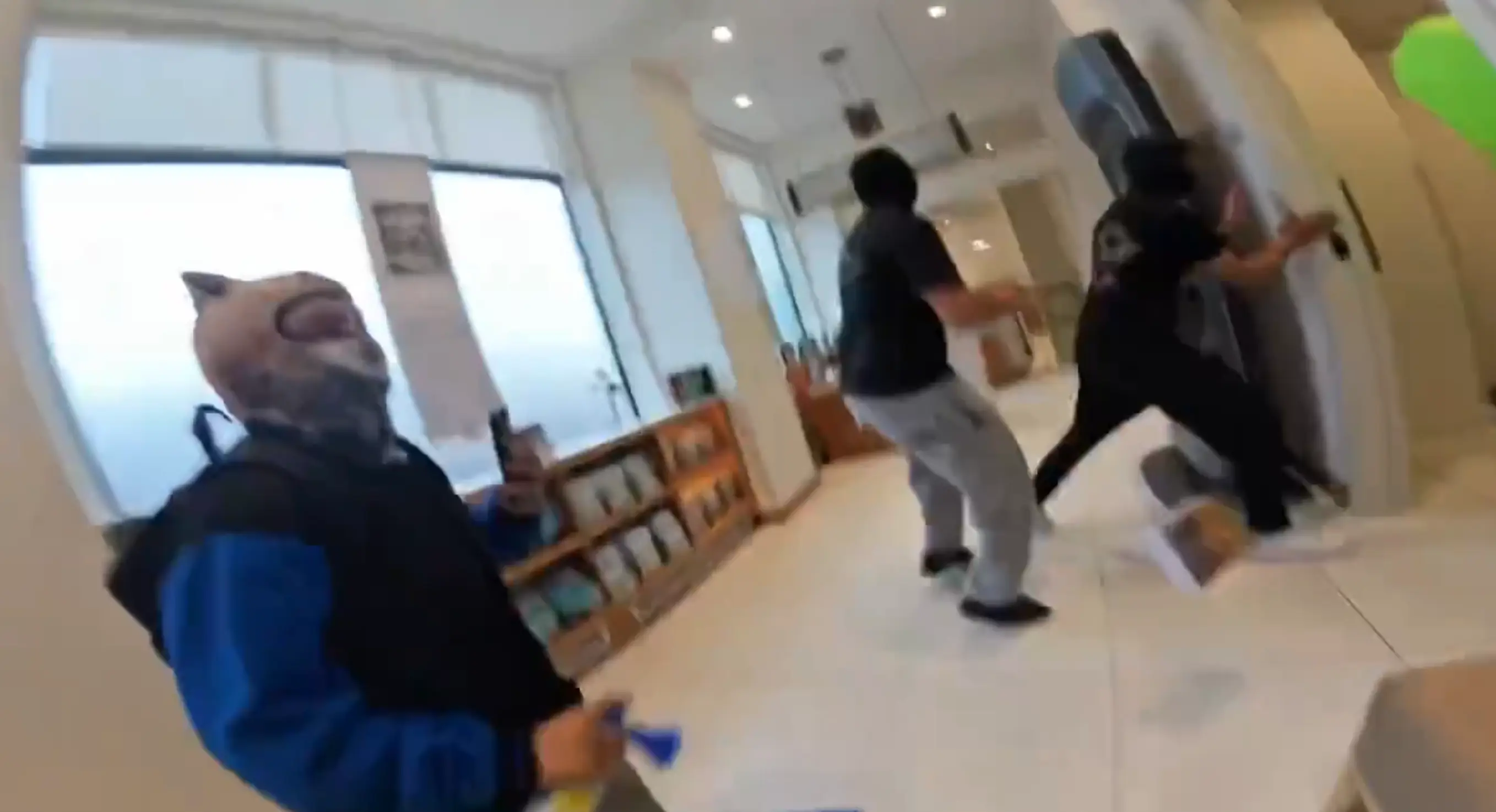 One video showed multiple people pull open the doors to a Scientology building and run deep inside (TikTok)
