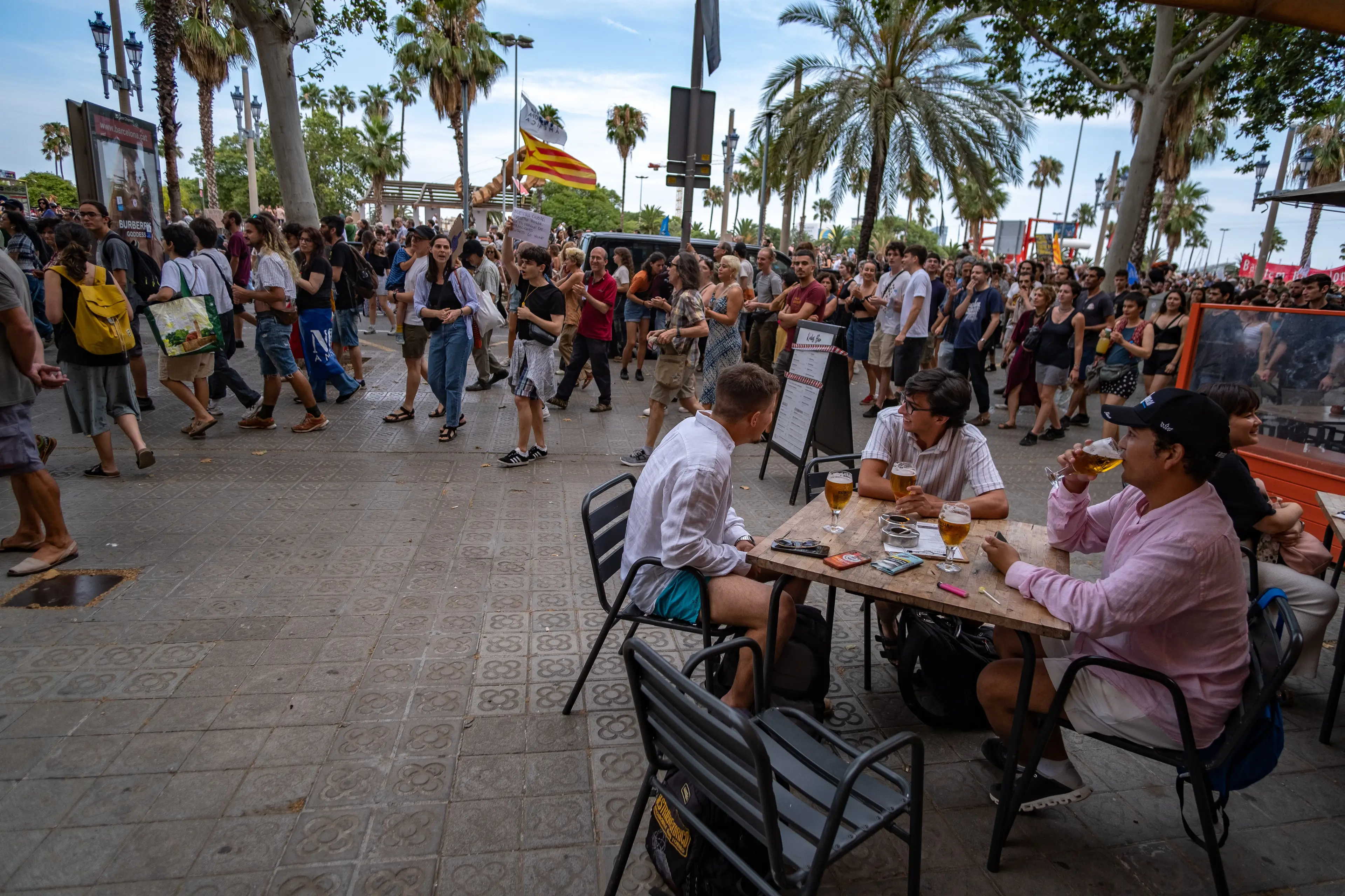 Crowds went by as tourists enjoyed a drink (Paco Freire/SOPA Images/LightRocket via Getty Images)