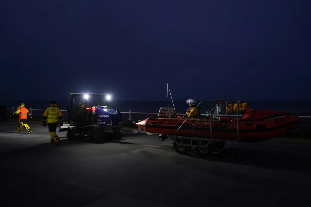 RNLI crews pictured returning to shore after bringing sailors back to shore, the cargo ship operator claims one of their crew is still missing (Ian Forsyth/Getty Images)