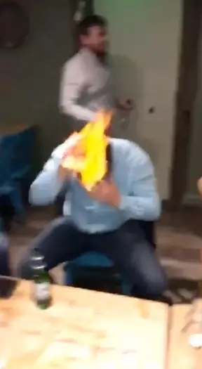 Within seconds each person appears to put their flame out, but one man seemed to struggle and looked to be in serious trouble if it wasn't the help of his friend.