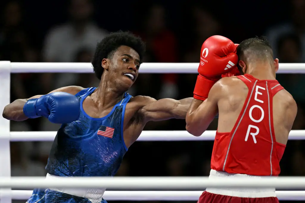 USA's Roscoe Hill punches Refugee Olympic Team's Omid Ahmadisafa (MOHD RASFAN/AFP via Getty Images)