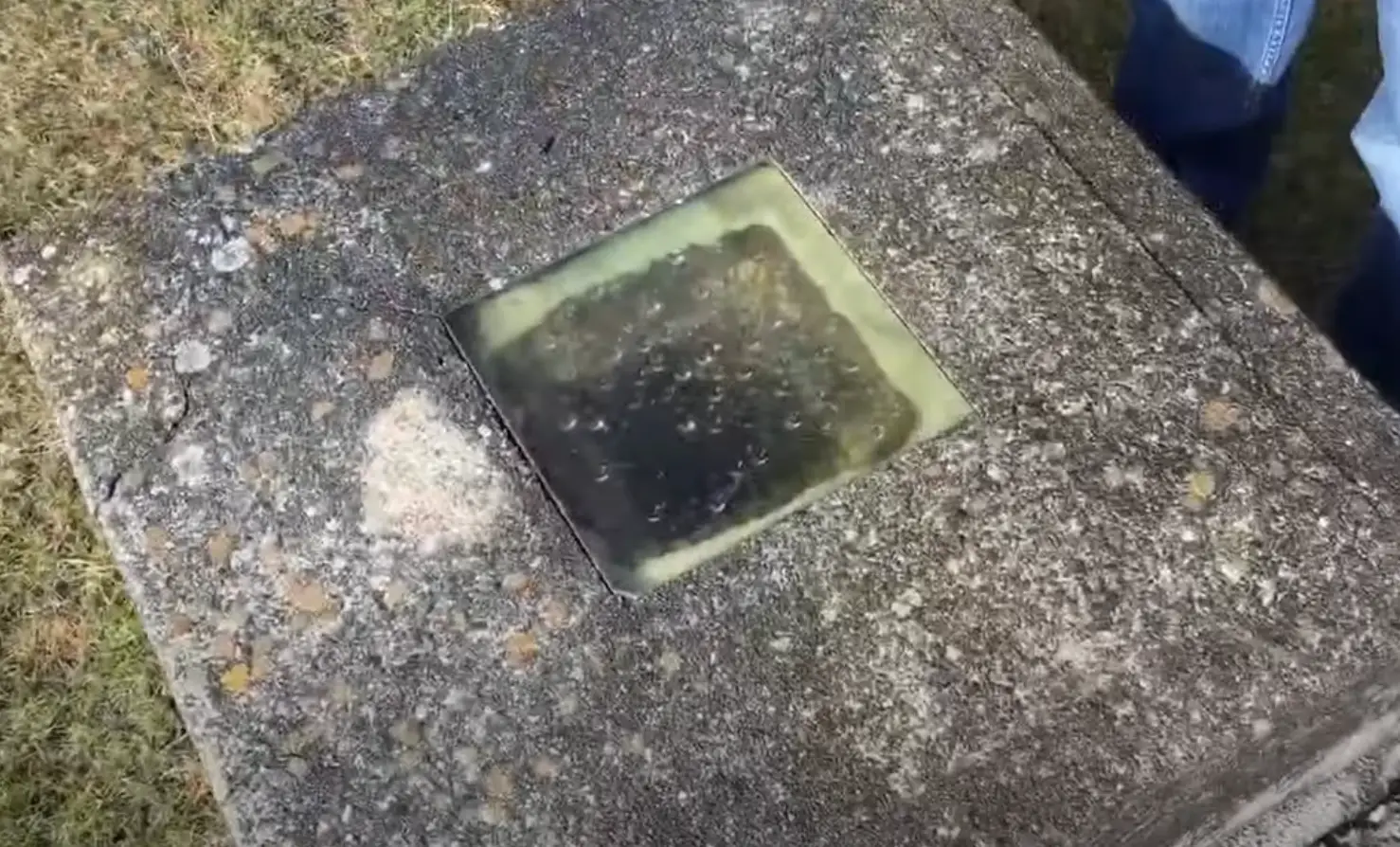 The grave of Timothy Clark Smith, sans bell (YouTube/Planet Weird)