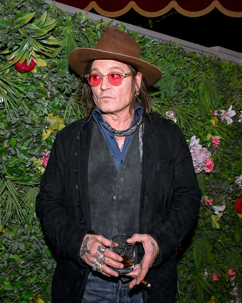 Johnny Depp was seen turning to grab mouthfuls of the foliage behind him (Photo by Denise Truscello/Getty Images for Drink Las Vegas)
