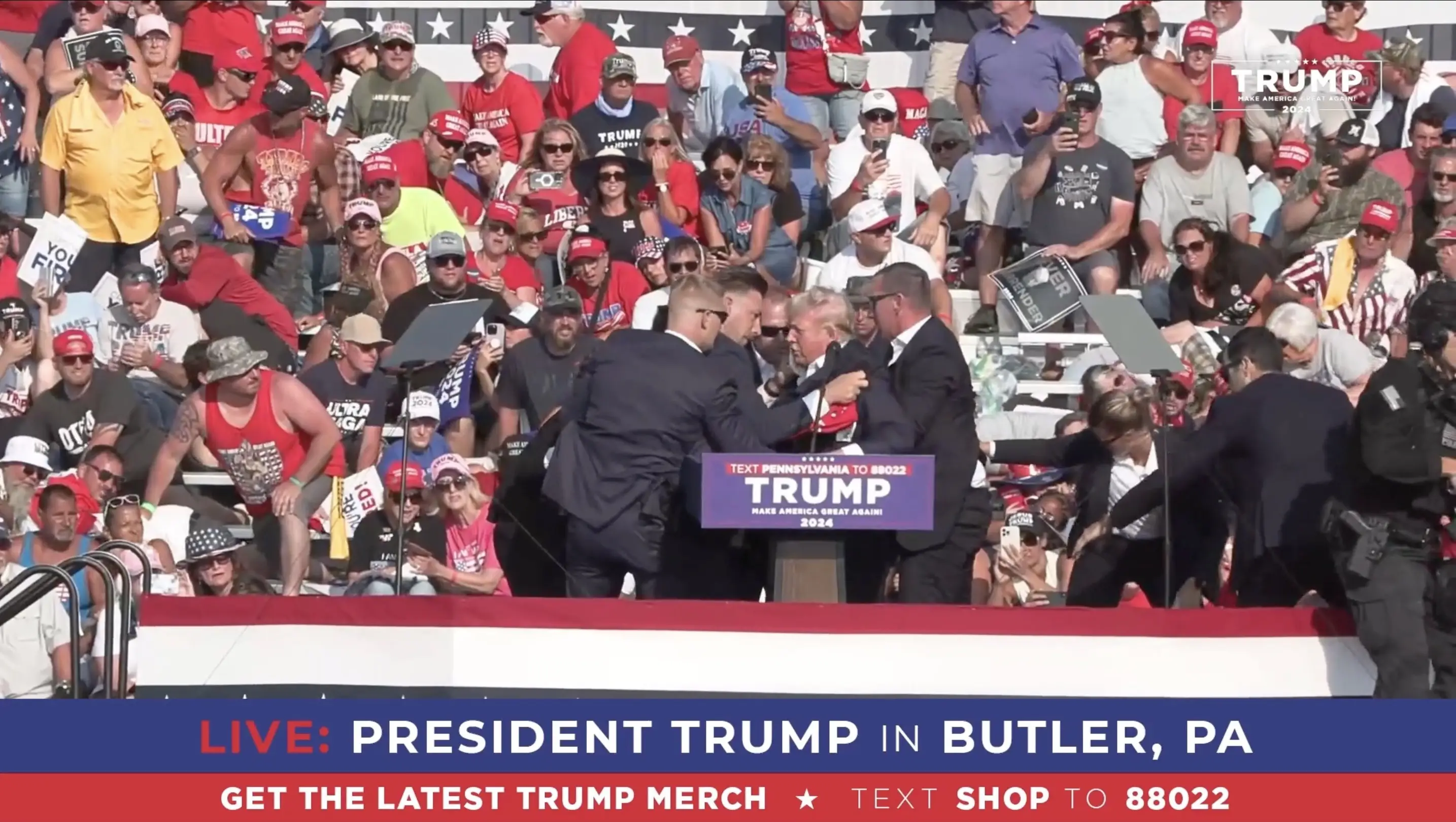 Trump is swarmed by Secret Service agents after the shots ring out. (Trump Campaign Office / Handout/Anadolu via Getty Images)
