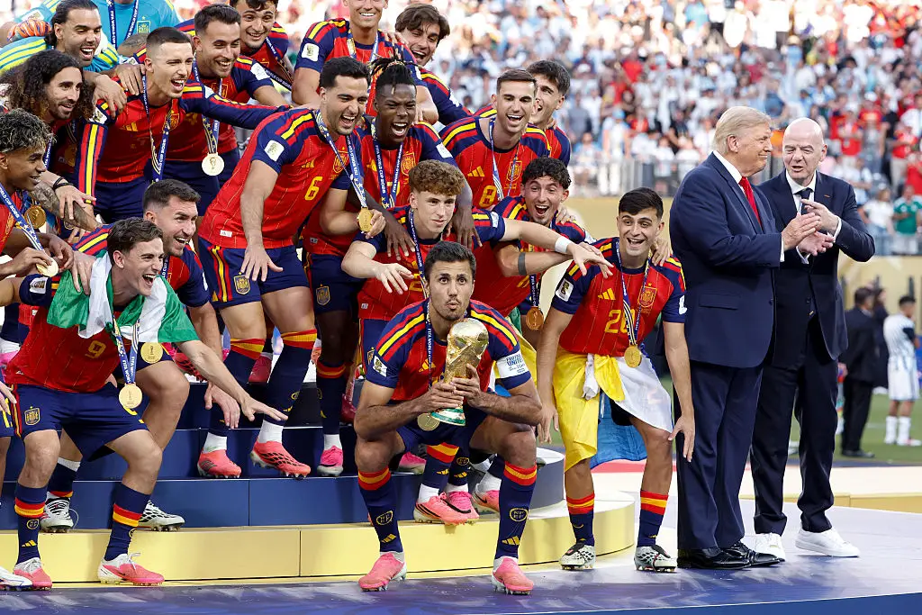 Despite it all Trump couldn't help himself a bit, as he didn't get off the stage for Spain's celebrations (Jean Catuffe/Getty Images)