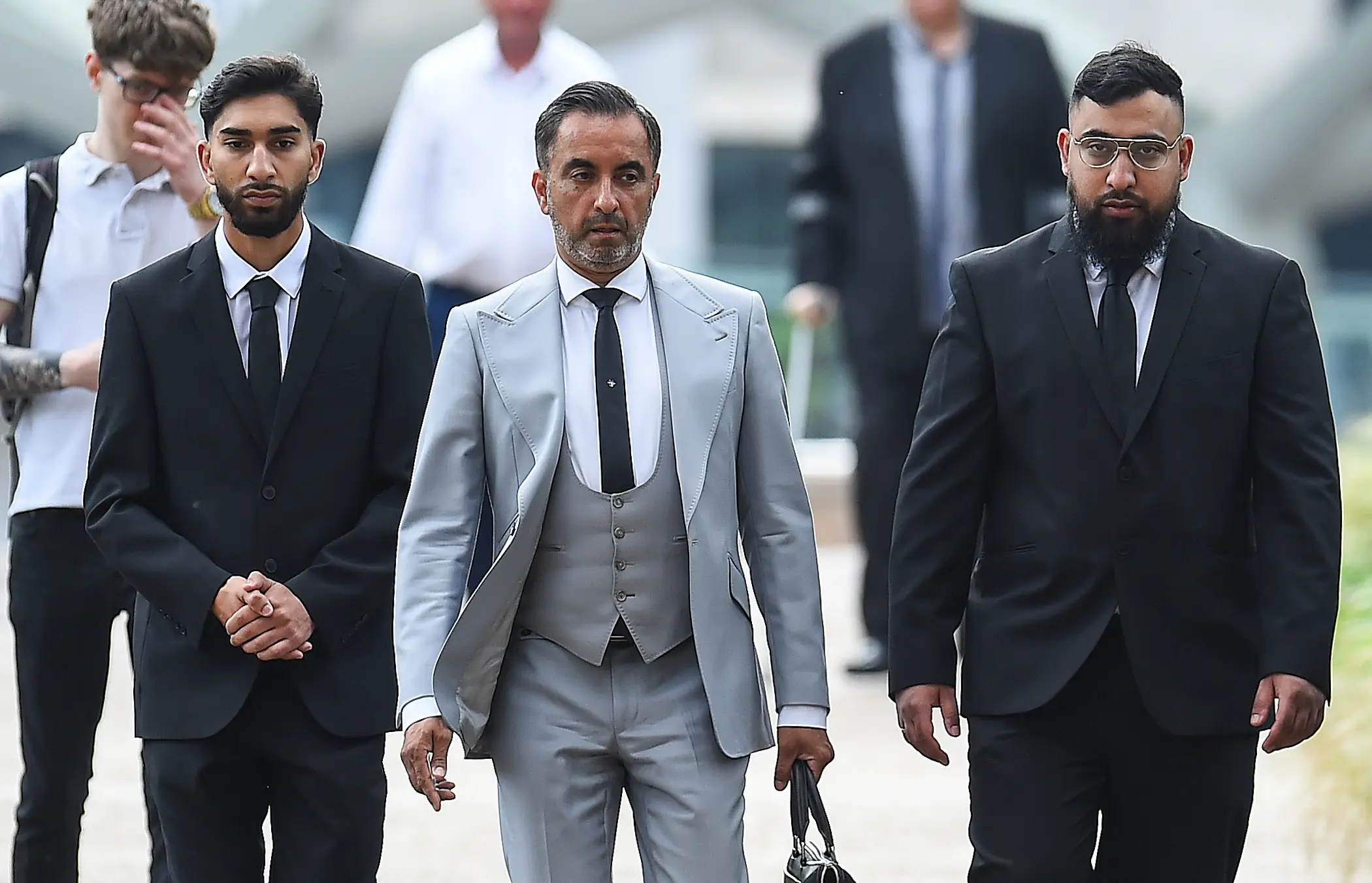 Human Rights lawyer Aamer Anwar with Mohammed Fahir Amaaz (left) and Muhammed Amaad (right) arriving at Liverpool Crown Court last year (PA)