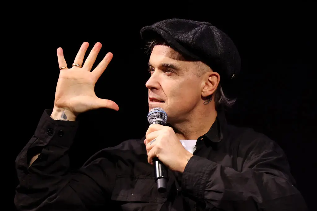 A fan in her 70s died after a fall at a Robbie Williams concert.