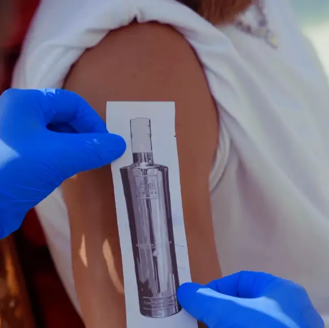 The tattoo is of an Blue Raspberry AU vodka bottle.