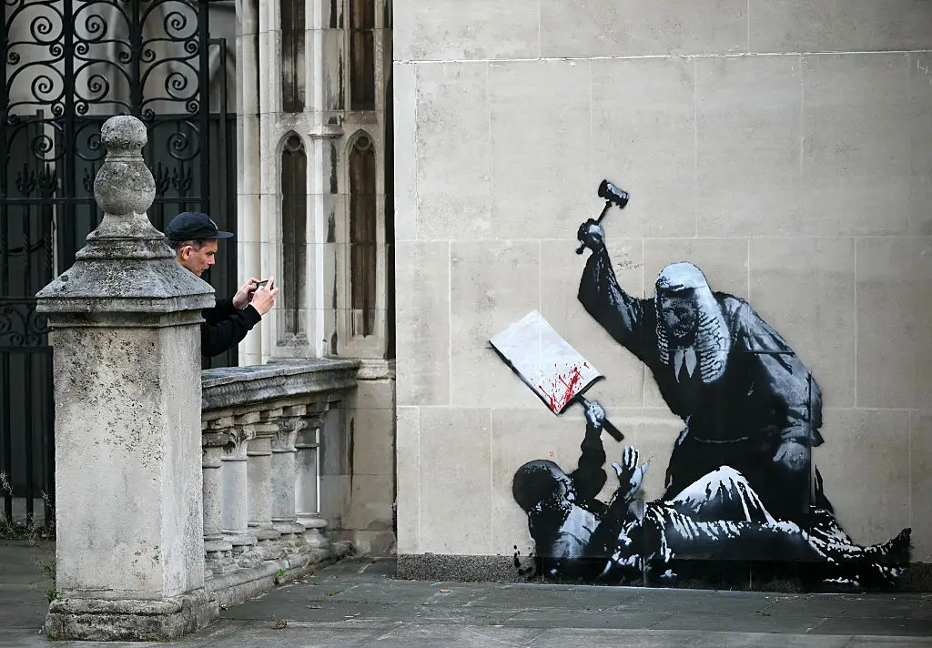 Banksy made headlines last September for his artwork on the wall of the The Royal Courts of Justice at Britain's High Court (JUSTIN TALLIS / AFP via Getty Images)